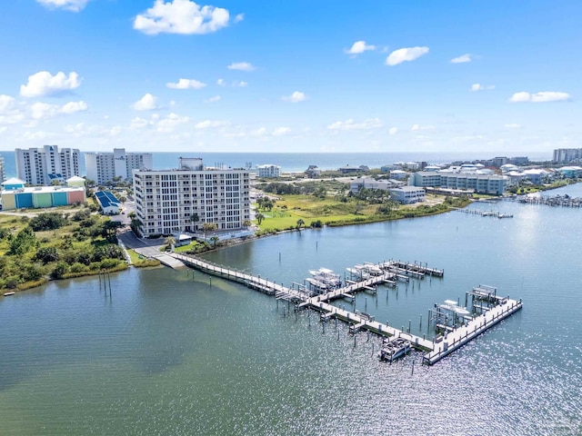 drone / aerial view featuring a water view and a view of city