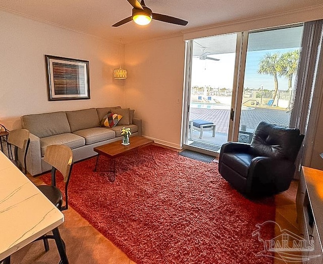 living area featuring carpet flooring and a ceiling fan