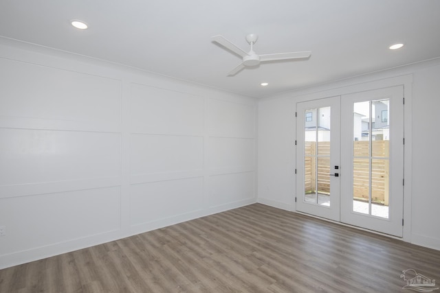 empty room with hardwood / wood-style flooring, ceiling fan, and french doors