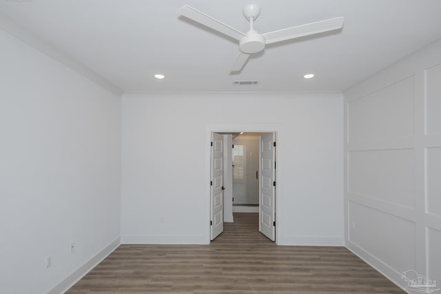 spare room with hardwood / wood-style floors, crown molding, and ceiling fan