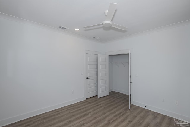 unfurnished bedroom featuring hardwood / wood-style flooring, ornamental molding, a closet, and ceiling fan