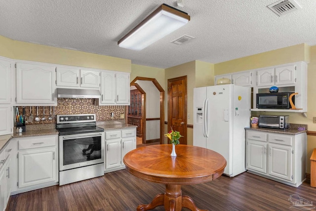 5816 Forest Ridge Dr, Pensacola, FL 32526 - kitchen featuring stainless steel range with electric cooktop, white refrigerator with ice dispenser, under cabinet range hood, black microwave, and white cabinets