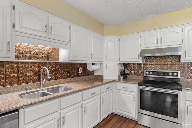 5816 Forest Ridge Dr, Pensacola, FL 32526 - kitchen featuring appliances with stainless steel finishes, under cabinet range hood, a sink, tasteful backsplash, and white cabinets