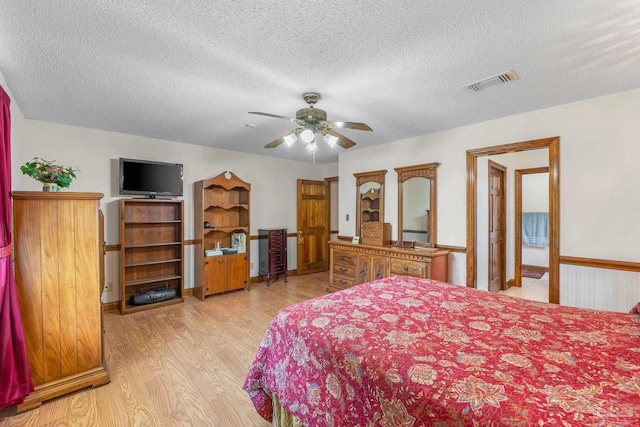 5816 Forest Ridge Dr, Pensacola, FL 32526 - bedroom with light wood-style floors, a textured ceiling, and ceiling fan