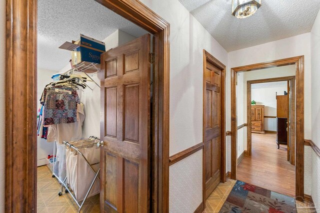 5816 Forest Ridge Dr, Pensacola, FL 32526 - hall with a textured ceiling and light wood finished floors