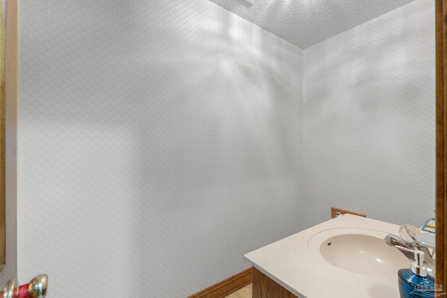 5816 Forest Ridge Dr, Pensacola, FL 32526 - bathroom featuring a textured ceiling and vanity