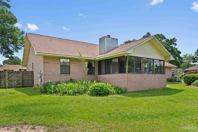 5816 Forest Ridge Dr, Pensacola, FL 32526 - rear view of house with brick siding, a chimney, a sunroom, and roof with shingles