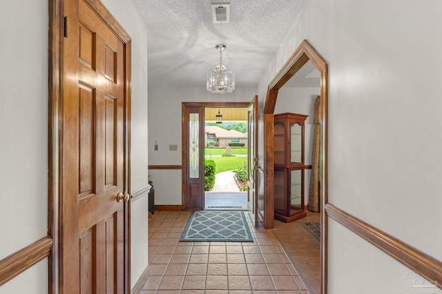5816 Forest Ridge Dr, Pensacola, FL 32526 - entrance foyer with a chandelier, a textured ceiling, and baseboards