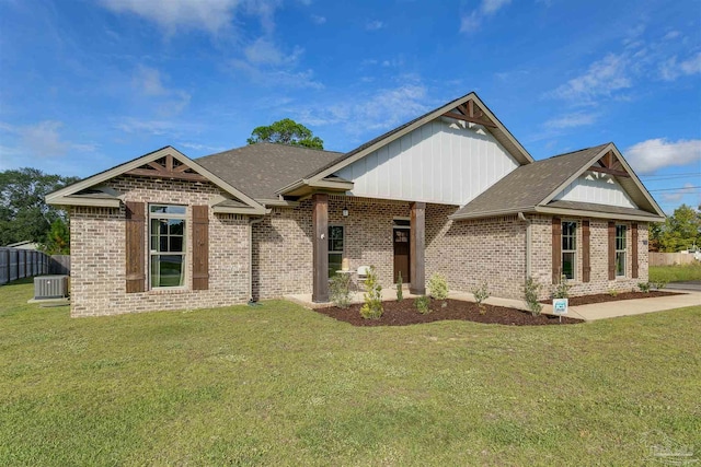 craftsman-style home featuring a front yard and cooling unit