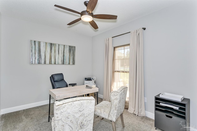 home office with baseboards, ceiling fan, and light colored carpet