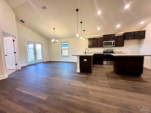 kitchen with stainless steel appliances, dark wood finished floors, a kitchen island, open floor plan, and recessed lighting