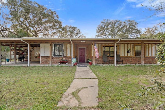 view of front of property with a front yard and brick siding