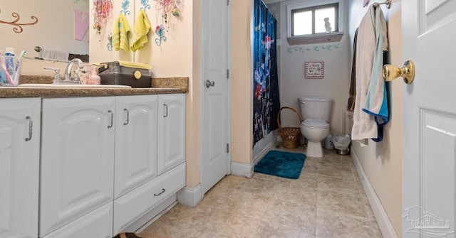 bathroom with baseboards, toilet, tile patterned floors, curtained shower, and vanity