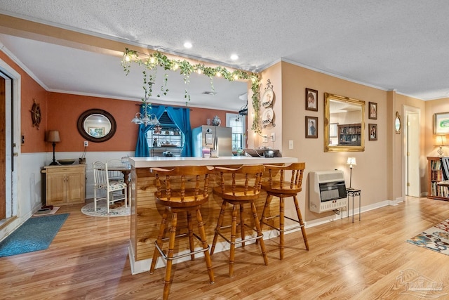 bar with bar, ornamental molding, wood finished floors, heating unit, and smart refrigerator