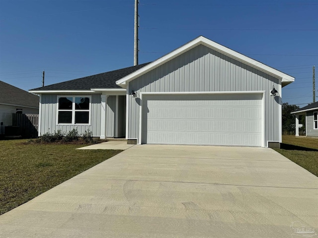 9691 Angel Oak Dr, Pensacola, FL 32526 - ranch-style house featuring a front yard, an attached garage, board and batten siding, and driveway