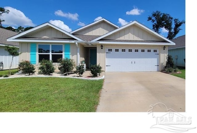 view of front of property with a garage and a front lawn