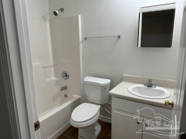 bathroom with tile patterned flooring, toilet, vanity, and washtub / shower combination