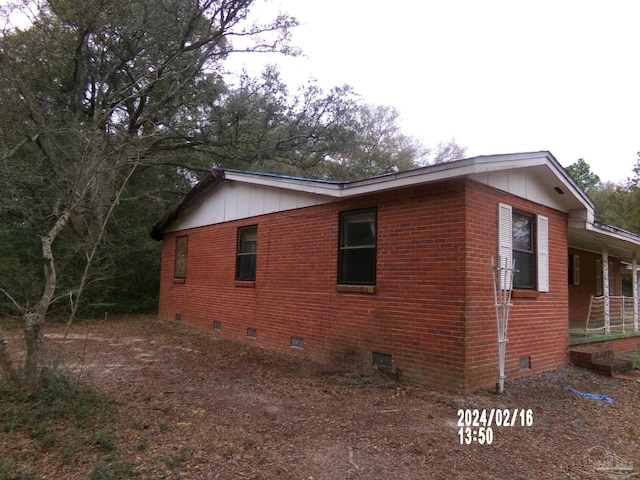 view of home's exterior featuring crawl space and brick siding