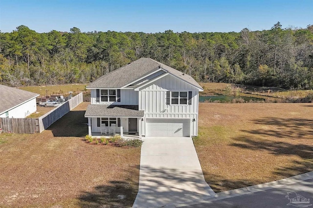 view of front property with a porch and a garage