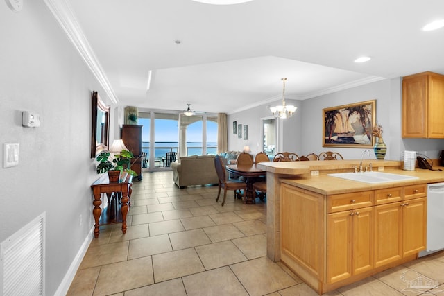 kitchen featuring sink, light tile patterned floors, a water view, ceiling fan with notable chandelier, and ornamental molding