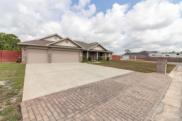 2255 Reed Ridge Ct, Navarre, FL 32566 - view of front facade with fence, a garage, decorative driveway, and a front yard