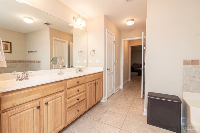 2255 Reed Ridge Ct, Navarre, FL 32566 - bathroom featuring a sink, a bathtub, visible vents, tile patterned floors, and double vanity