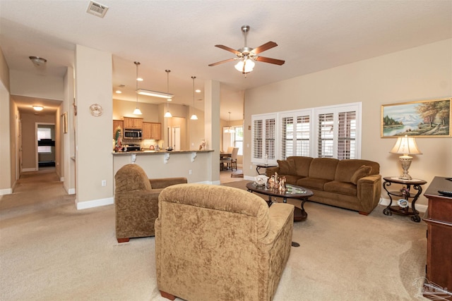 2255 Reed Ridge Ct, Navarre, FL 32566 - living area featuring a ceiling fan, baseboards, visible vents, and light colored carpet