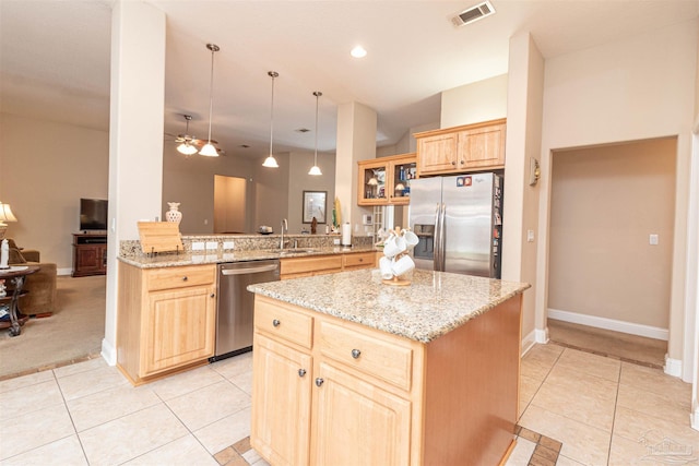 2255 Reed Ridge Ct, Navarre, FL 32566 - kitchen with light brown cabinetry, light tile patterned floors, visible vents, and appliances with stainless steel finishes