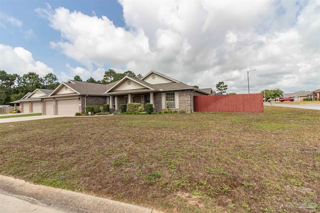 2255 Reed Ridge Ct, Navarre, FL 32566 - craftsman-style house with driveway, brick siding, fence, a garage, and a front lawn