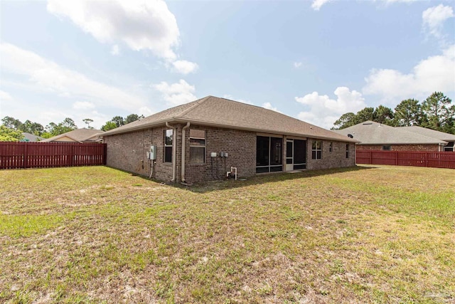 2255 Reed Ridge Ct, Navarre, FL 32566 - rear view of property featuring a fenced backyard, a sunroom, a yard, and brick siding