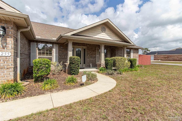 2255 Reed Ridge Ct, Navarre, FL 32566 - view of front facade with a porch, a front lawn, and brick siding