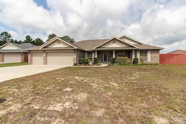 2255 Reed Ridge Ct, Navarre, FL 32566 - ranch-style house featuring driveway, brick siding, fence, a garage, and a front lawn