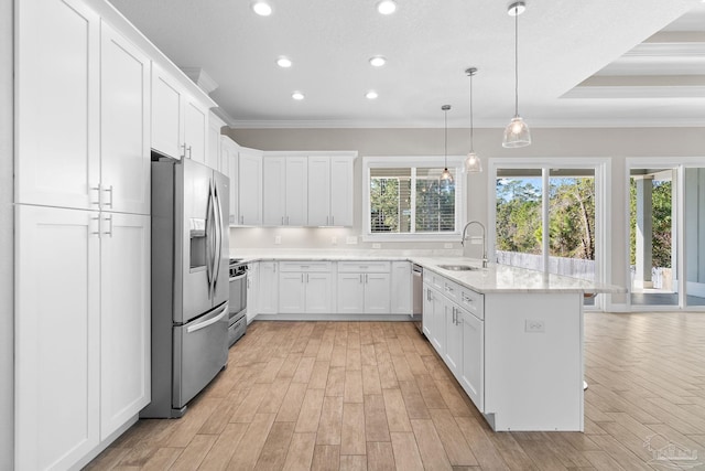 kitchen with white cabinets, hanging light fixtures, crown molding, sink, and appliances with stainless steel finishes