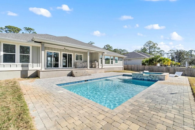 view of swimming pool featuring an in ground hot tub and a patio