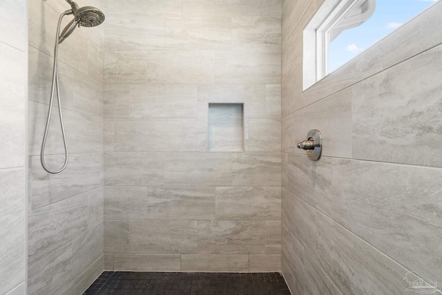 bathroom with a tile shower