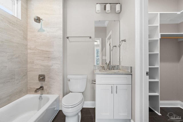 full bathroom featuring vanity, ornamental molding, tiled shower / bath combo, and toilet