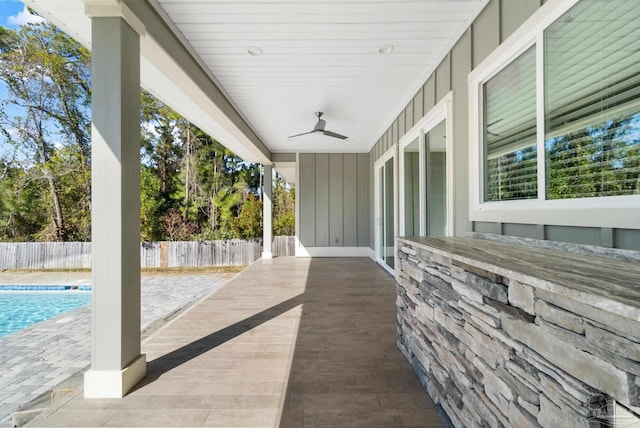 view of patio featuring a fenced in pool and ceiling fan