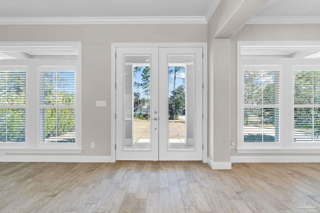 entryway featuring light wood-type flooring and crown molding