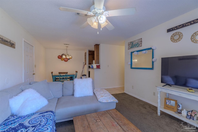 carpeted living room featuring ceiling fan with notable chandelier and a textured ceiling