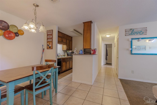 kitchen featuring pendant lighting, black dishwasher, and light tile patterned flooring