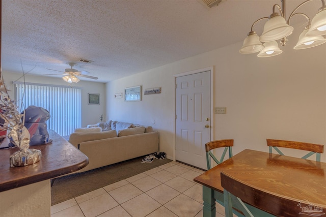 tiled living room featuring ceiling fan and a textured ceiling