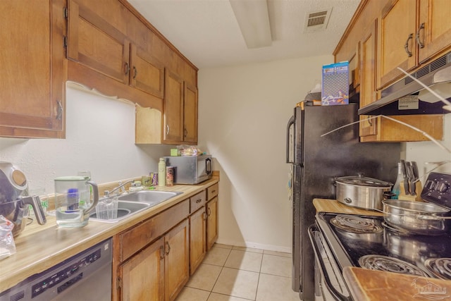 kitchen featuring dishwasher, sink, electric range oven, and light tile patterned floors