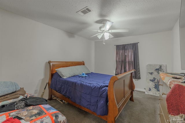 carpeted bedroom with ceiling fan and a textured ceiling