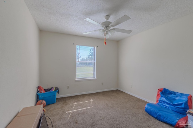 interior space featuring light carpet, ceiling fan, and a textured ceiling