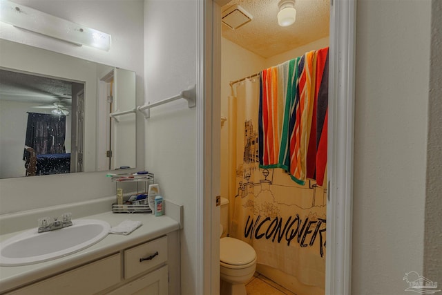 bathroom with ceiling fan, a shower with shower curtain, vanity, a textured ceiling, and toilet