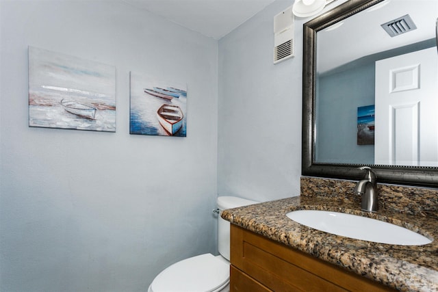 bathroom with toilet and vanity