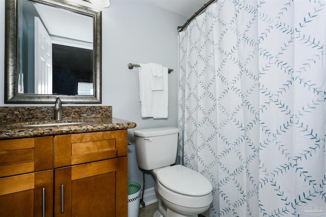 bathroom with toilet, vanity, tile patterned floors, and walk in shower