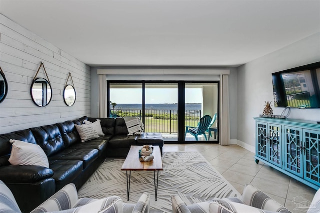 living room featuring light tile patterned flooring and wooden walls