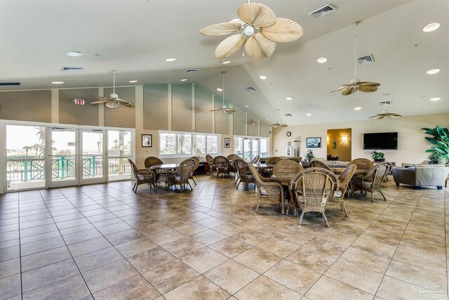 tiled dining room with high vaulted ceiling