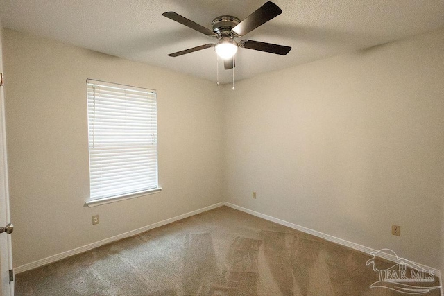 unfurnished room featuring carpet floors, a ceiling fan, and baseboards